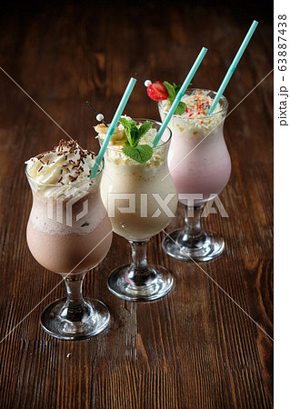 Different soft drinks in transparent jugs on a dark wooden background. menu for catering Different soft drinks in transparent jugs on a dark wooden background. menu for catering 63887438