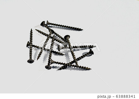 Long dark metal screws for mounting on a wooden surface .. Long dark metal screws for mounting on a wooden surface .. 63888341