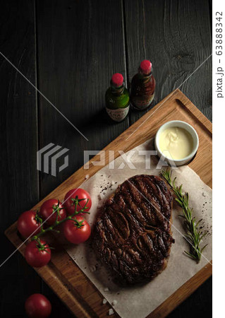 Meat steak on a wooden board. catering menu 63888342