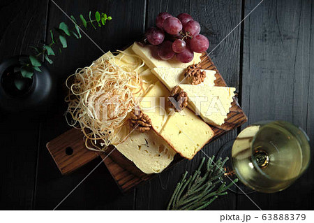 Glass of cold white wine with cheese snack on a wooden. catering menu 63888379