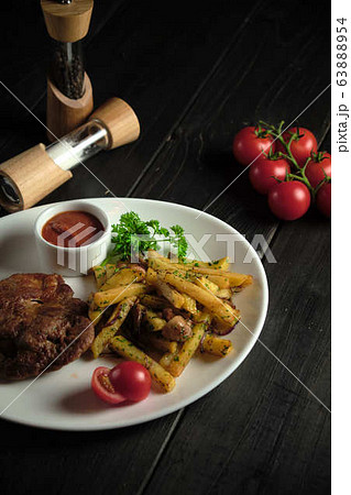 Meat medallion and french fries . catering menu 63888954