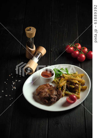 Meat medallion and french fries . catering menu 63889392