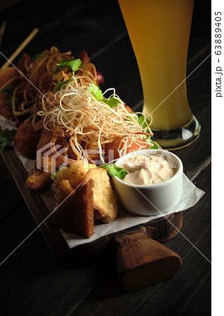 Glass of cold beer with appetizer. catering menu 63889405