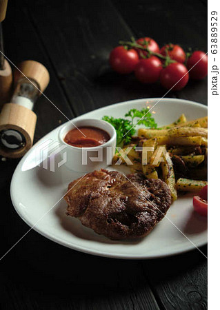 Meat medallion and french fries . catering menu 63889529