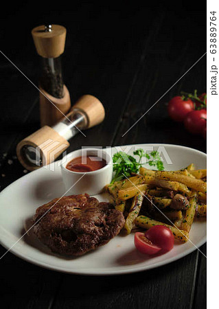 Meat medallion and french fries . catering menu 63889764