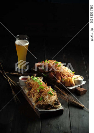 Glass of cold beer with appetizer. catering menu 63889769