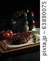 Meat steak on a wooden board. catering menu 63890075