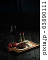 Meat steak on a wooden board. catering menu 63890111