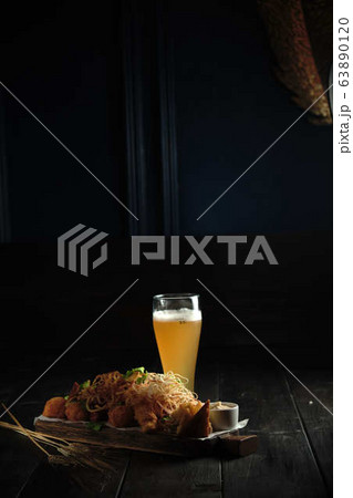 Glass of cold beer with appetizer. catering menu 63890120