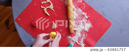 The man makes the gingerbread cut cookies made The man makes the gingerbread cut cookies made 63891757