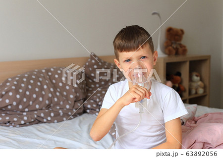 A child with an inhaler. Boy got sick 63892056
