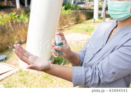 Women hand use alcohol spray to prevent the spread of germs, bacteria and viruses. Measures to prevent coronavirus infection Women hand use alcohol spray to prevent the spread of germs, bacteria and viruses. Measures to prevent coronavirus infection 63894541