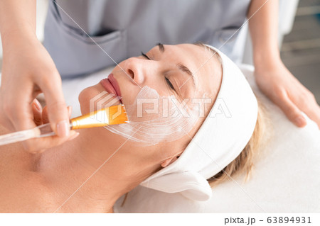 Applying facial mask Applying facial mask 63894931
