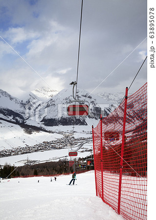 Chair-lift, snowy ski slope with snowboarders and Chair-lift, snowy ski slope with snowboarders and 63895078