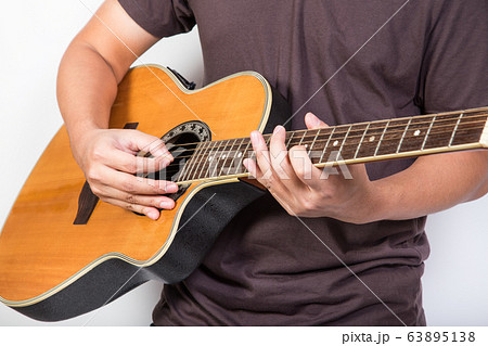 man playing guitar acoustic wearing t-shirt 63895138