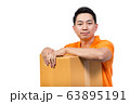 young man holding package box smile face wearing orange uniform polo shirt white background 63895191
