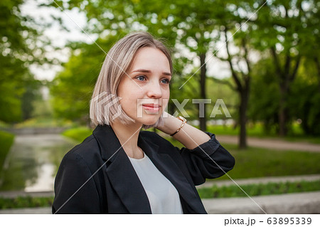 Pretty young woman outdoors portrait 63895339