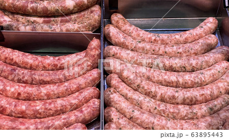 Homemade stuffed meat sausages in a store  63895443