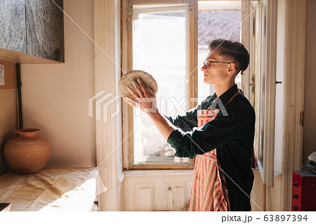 Male potter works with clay. Hand's of man creating ceramic product 63897394