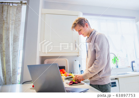 Young caucasian man working from home. Freelancer Young caucasian man working from home. Freelancer 63897753