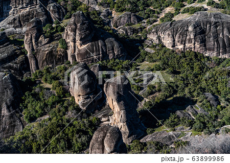 Aerial view of Unesco monument Meteora, the mountains, the landmark of Greek, sunny weather, fog, haze over a valley 63899986