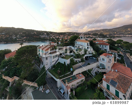 France, Saint-Jean-Cape-Ferrat, 15 December 2019: Aerial view of most expensive place in French Riviera at sunset, terraces of country houses and estates, pools, Chaise lounges, pink clouds 63899987