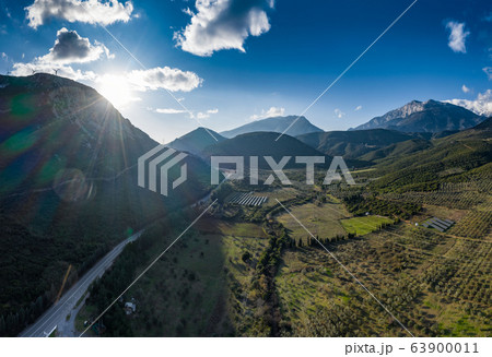 Aerial panorama of valley, morning fog over mountains, Twisting road, Tops and slopes of mountains 63900011