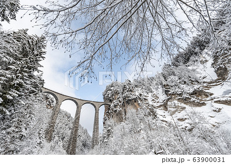 The Landwasser Viaduct with Railway without famous train at winter, landmark of Switzerland, snowing, river and mountains The Landwasser Viaduct with Railway without famous train at winter, landmark of Switzerland, snowing, river and mountains 63900031