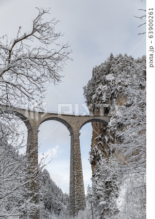 The Landwasser Viaduct with Railway without famous train at winter, landmark of Switzerland, snowing, river and mountains 63900261