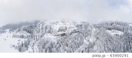 Aerial View of the Landwasser Viaduct with Railway without famous train at winter, landmark of Switzerland, snowing, river and mountains Aerial View of the Landwasser Viaduct with Railway without famous train at winter, landmark of Switzerland, snowing, river and mountains 63900291