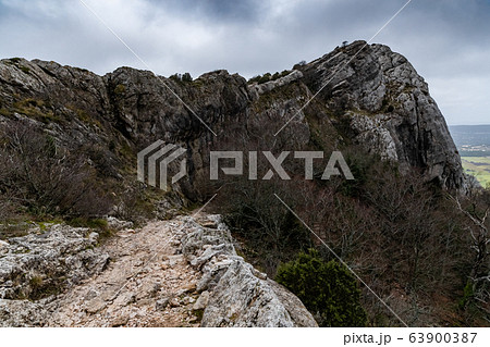 The mountain over grotto of Mary Magdalene at cloudy weather, clouds over a valley, a dry grass 63900387