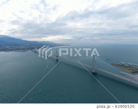 Aerial view of long cable-stayed Rio bridge in Greece at clouds weather, Ferry station 63900520