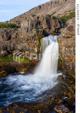 Iceland waterfall closeup view of the gods cliff with long exposure smooth motion of water in summer landscape 63900754