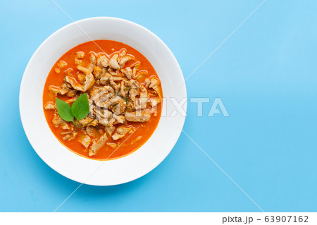 Panaeng Curry with pork  in white bowl on blue 63907162