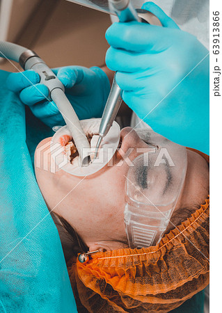 The patient visits the dentist for a dental 63913866