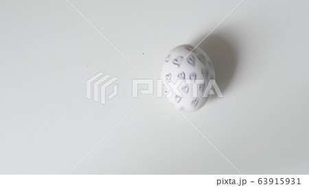 Egg spinning.Chicken egg spinning on white background top view. Egg spinning and rolling on the white background Happy Easter.Easter painted egg spinning on a white background. Egg spinning.Chicken egg spinning on white background top view. Egg spinning and rolling on the white background Happy Easter.Easter painted egg spinning on a white background. 63915931