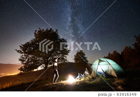 Couple tourists resting at night camping under stars 63916349