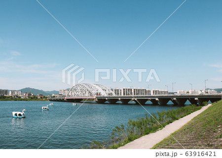 Duck boat and bridge and apartment on riverside park in Chuncheon, Korea 63916421