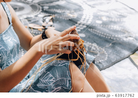 Female weaving basket on the craft workshop. Hands holding the craftwork, close up shot Female weaving basket on the craft workshop. Hands holding the craftwork, close up shot 63917762