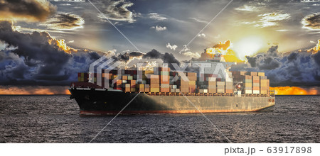 Mighty container ships in ocean at sunrise 63917898