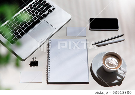 Creative and cozy workplace at home office, inspirational mock up with plant shadows on table surface Creative and cozy workplace at home office, inspirational mock up with plant shadows on table surface 63918300