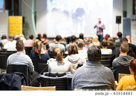 Business speaker giving a talk at business conference event. Business speaker giving a talk at business conference event. 63918883