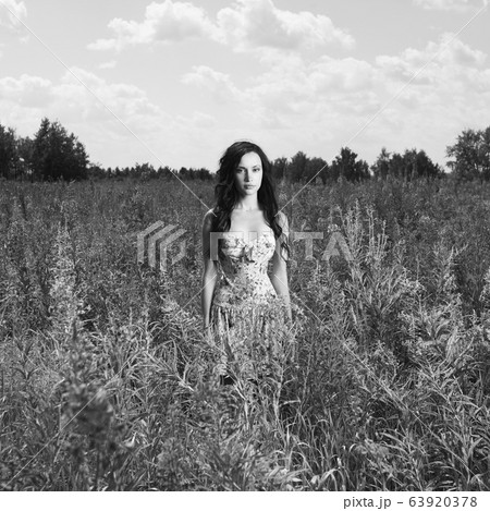 Lady in a flower meadow Lady in a flower meadow 63920378