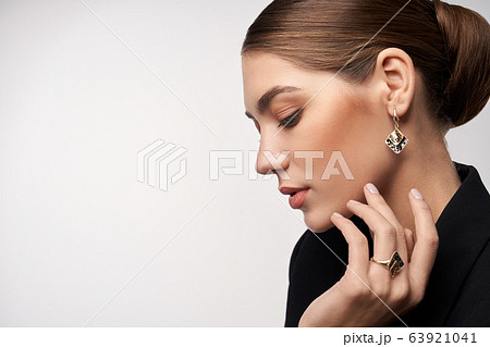 Model demonstrating earrings and ring. Model demonstrating earrings and ring. 63921041