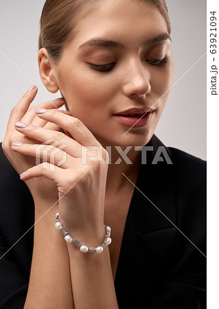 Young brunette model demonstrating jewelry. 63921094