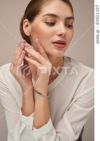 Model demonstrating bracelet, isolated on gray. Model demonstrating bracelet, isolated on gray. 63921107
