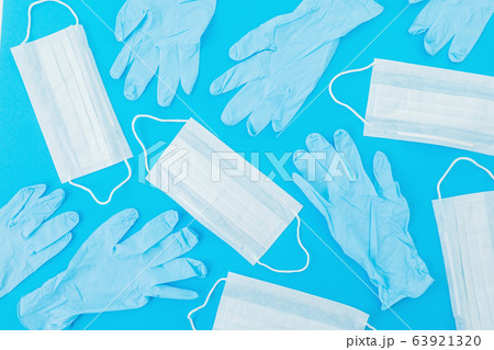 Medical masks for protection from virus and bacteria on a blue background. Flat lay Medical masks for protection from virus and bacteria on a blue background. Flat lay 63921320