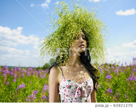 Young beautiful girl picks flowers in the field. Young beautiful girl picks flowers in the field. 63921370