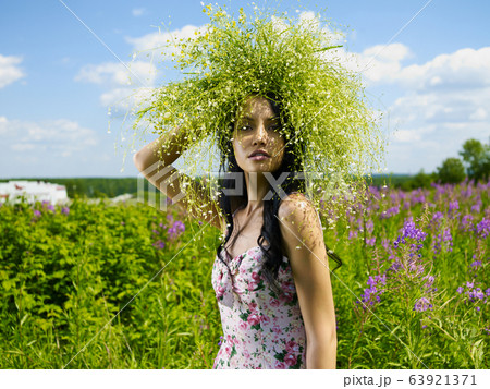 Young beautiful girl picks flowers in the field. 63921371