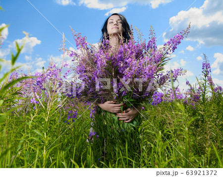 Young beautiful girl picks flowers in the field. Young beautiful girl picks flowers in the field. 63921372